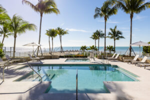 Private pool and hot tub with lounge chairs facing ocean at Islands of Islamorada resort in Florida Keys.