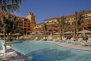 Resort pool and lounge chairs at Eau Palm Beach Resort & Spa in Palm Beach, Florida.