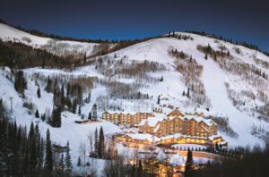 View of Deer Valley Ski Resort lit up at night in the winter.