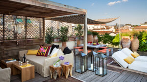 Colorful pillows and neutral furniture on outdoor rooftop patio of Inspirato luxury villa in Florence.