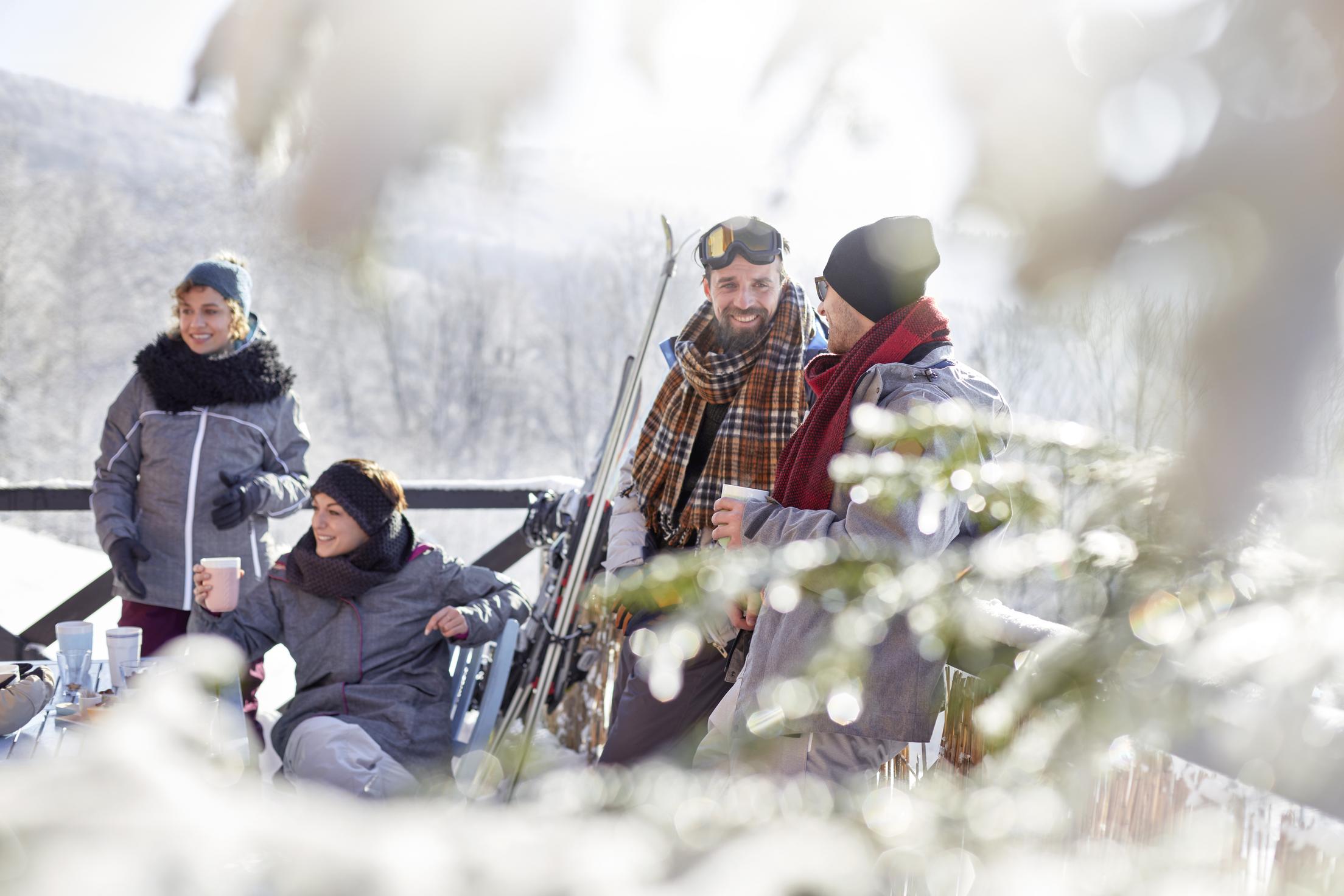 Inspirato members enjoying après-ski in style, drinking hot cocoa.