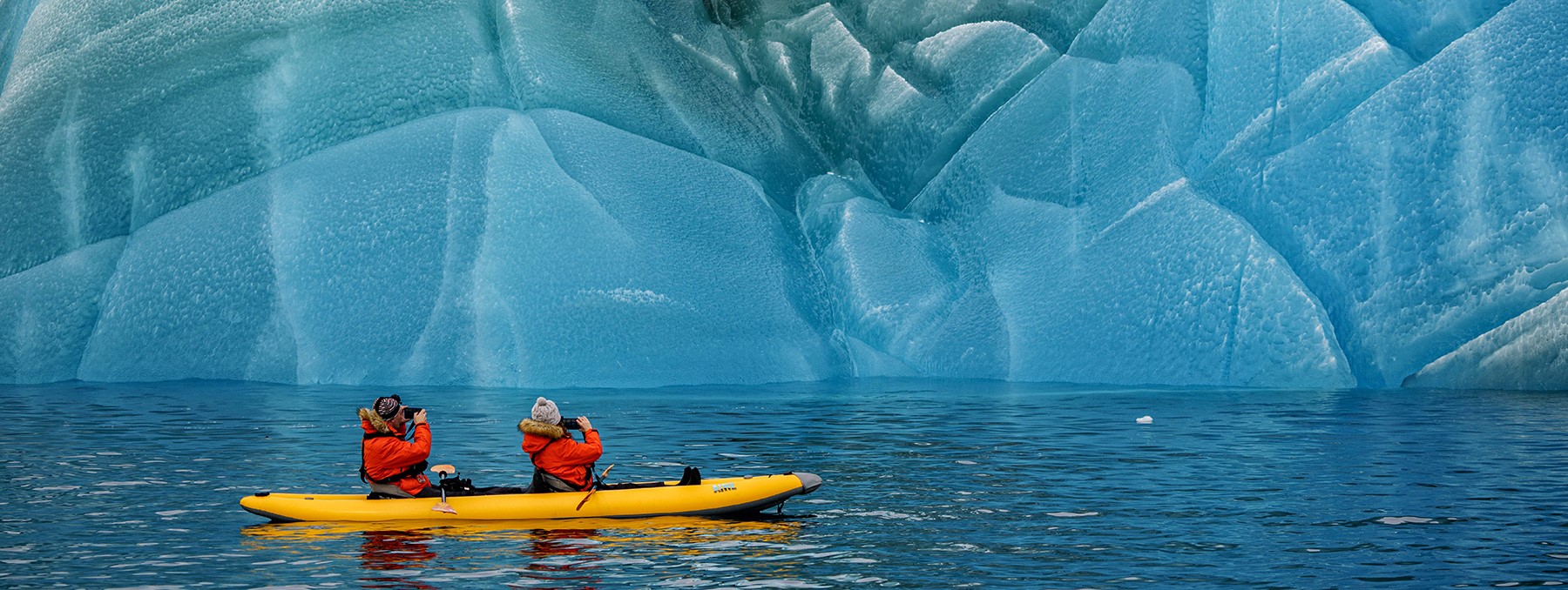Inspirato members kayaking among icebergs on the 2022 Inspirato Antarctica cruise