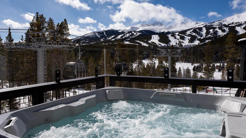 Cimarron hot tub with the Breckenridge resort gondola and mountain in the background.