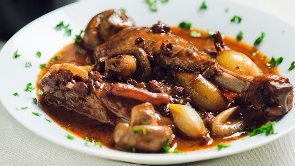 A coq au vin platted meat dish.