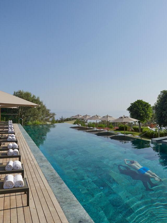 person swimming in infinity edge pool in bodrum