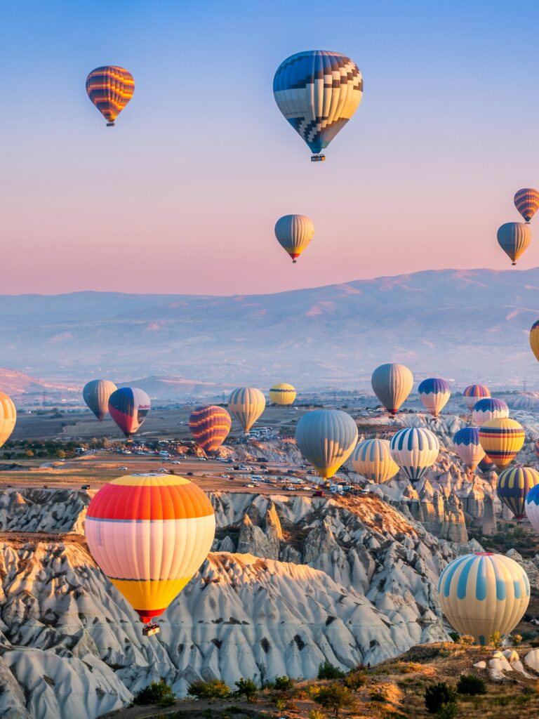 Hot air balloons flying above Cappadocia