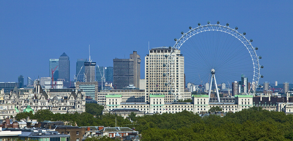 Panoramic view of London featuring the iconic London Eye and city skyline, as seen from COMO Metropolitan, an Inspirato hotel.