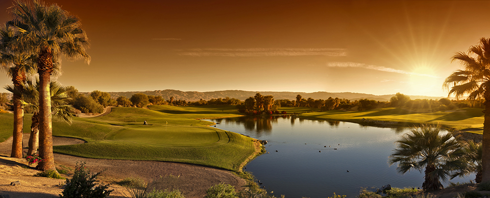 Sunset over a desert golf course and palm-lined fairways in Palm Springs, California — an Inspirato luxury travel destination offering relaxation and adventure.