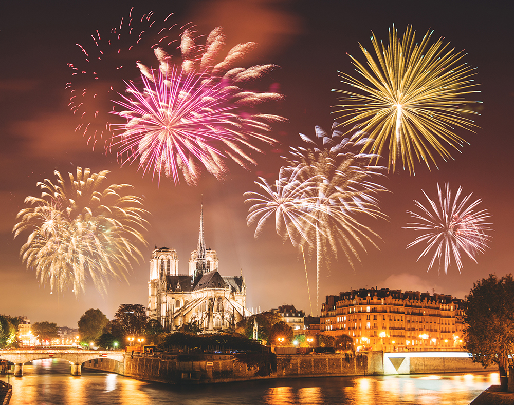 Fireworks over Notre-Dame Cathedral and the Seine River in Paris, France during New Year’s Eve celebrations in the heart of the city
