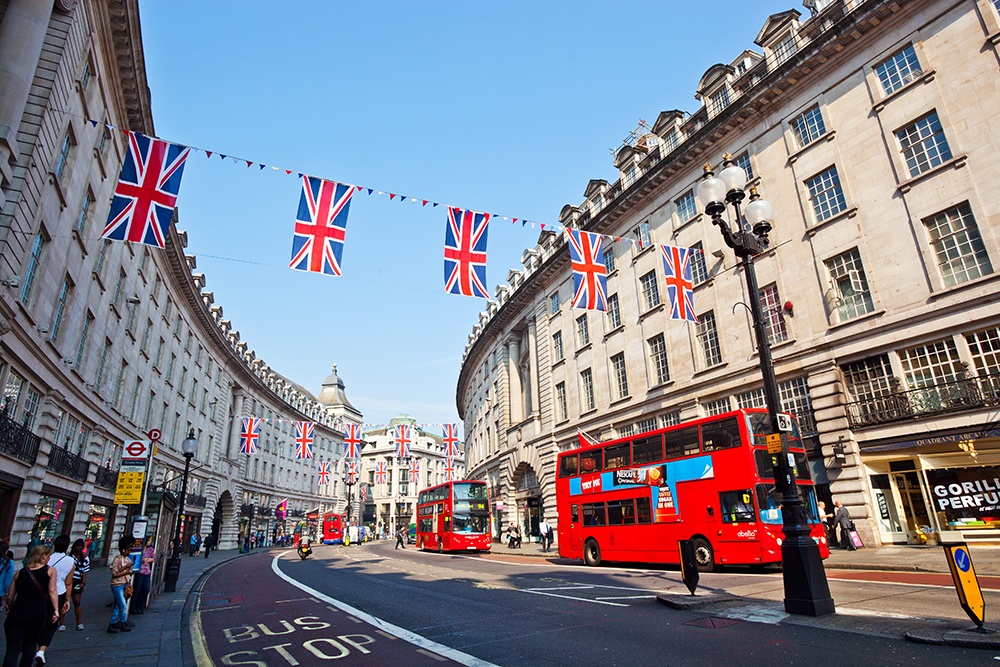Oxford street in London, with Union Jack bunting and double decker red busses