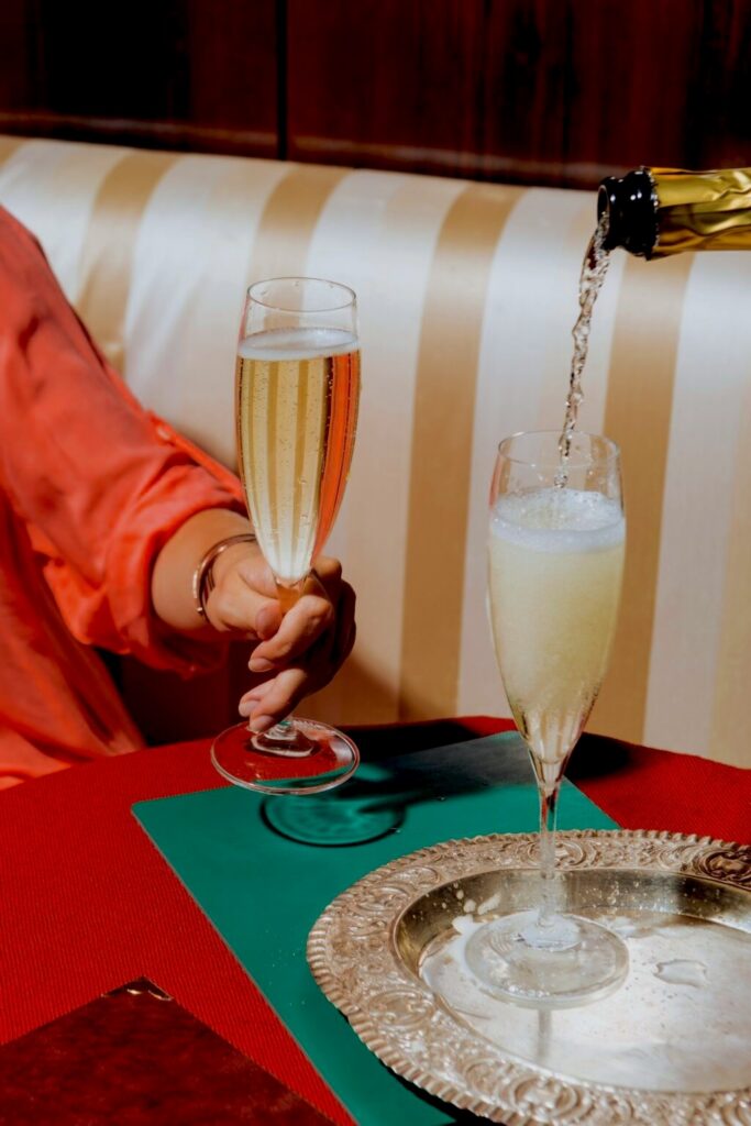 champagne being poured into a flute at christmas