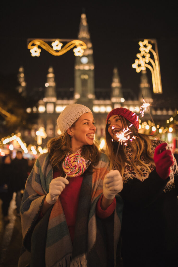 Two female friends enjoying a holiday market in Vienna